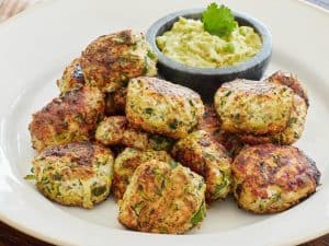 Chicken Zucchini Poppers served on white plate with side of guacamole