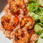 Mexican Style Shrimp and Rice served with a side salad on white plate