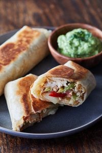 Easy Chicken Chimichangas on a gray plate with a side of guacamole