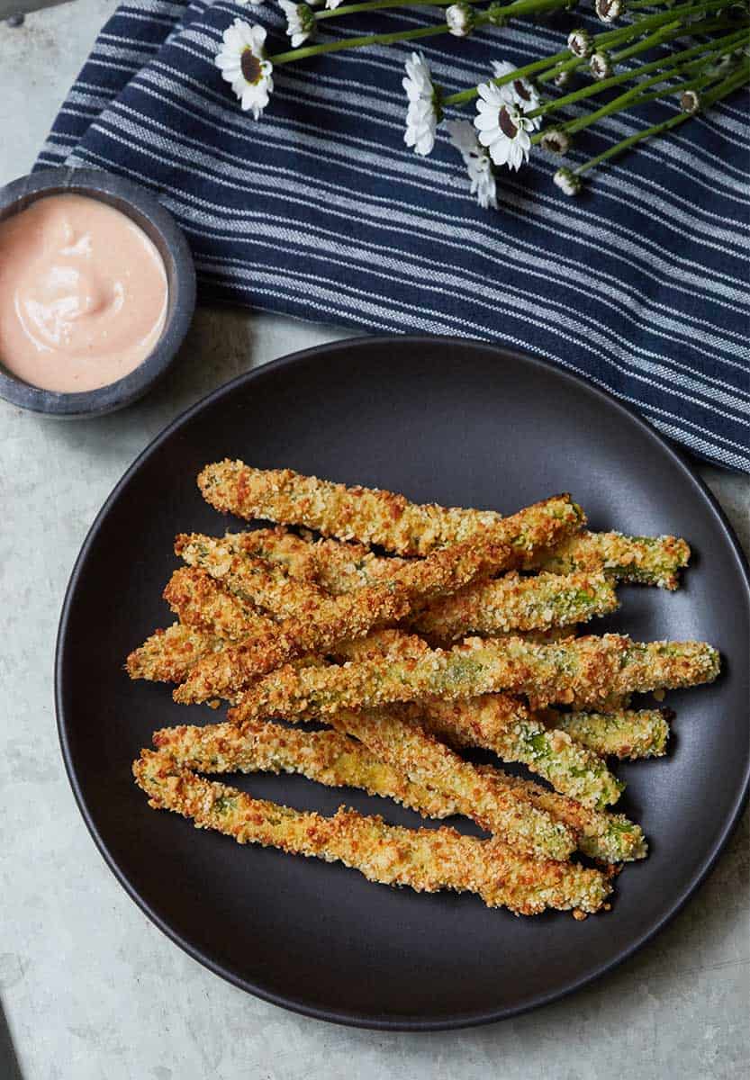 Asparagus Fries served on black plate and side of sauce