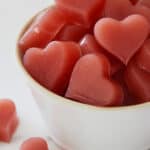 Apple Cider Vinegar Gummy Hearts stacked in a white bowl