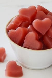Apple Cider Vinegar Gummy Hearts stacked in a white bowl