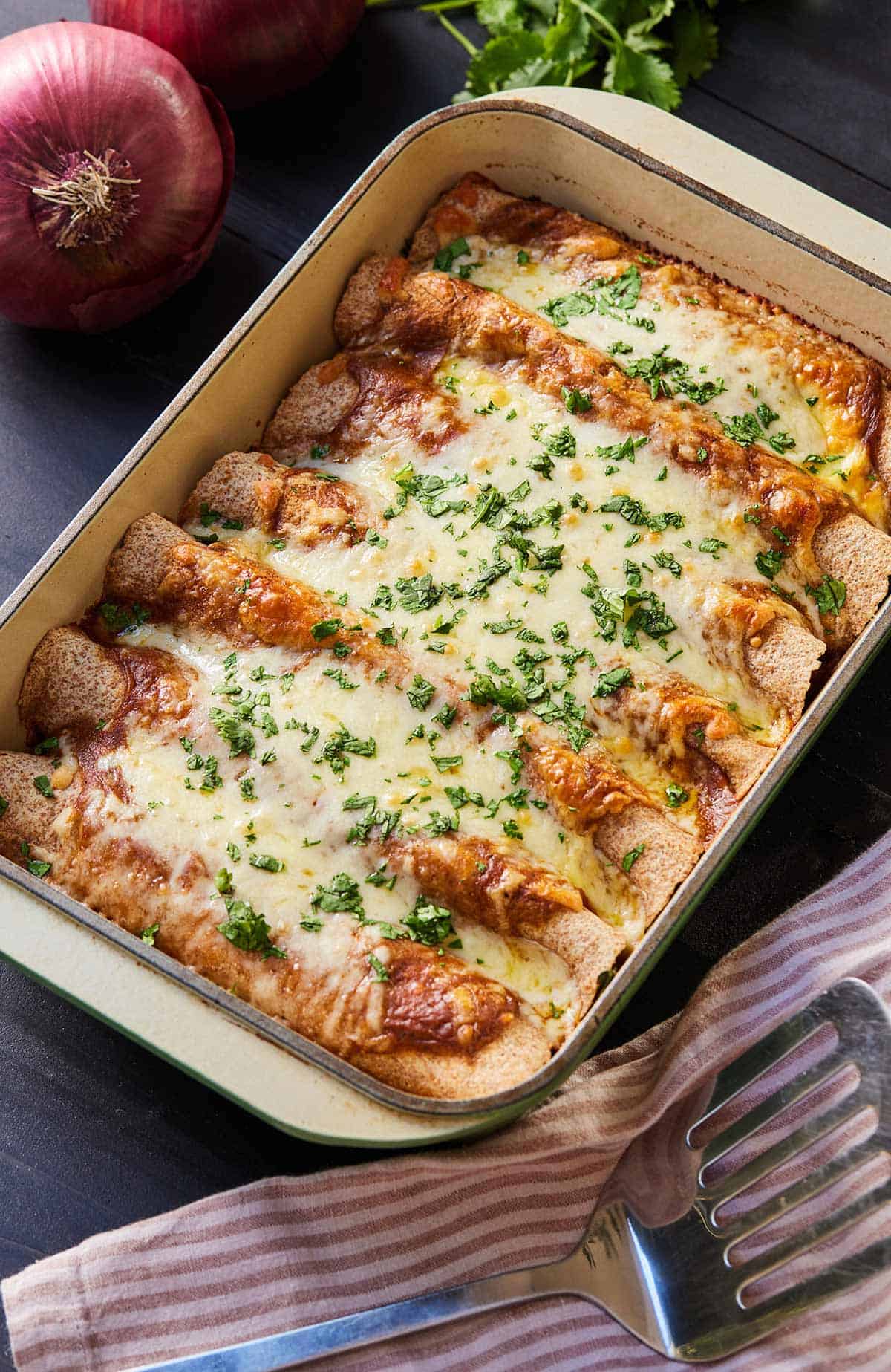 Overhead view of a casserole dish with a baked vegetarian enchiladas.