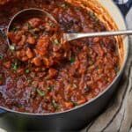 Pinterest graphic of vegetarian chili in a Dutch oven with a ladle.