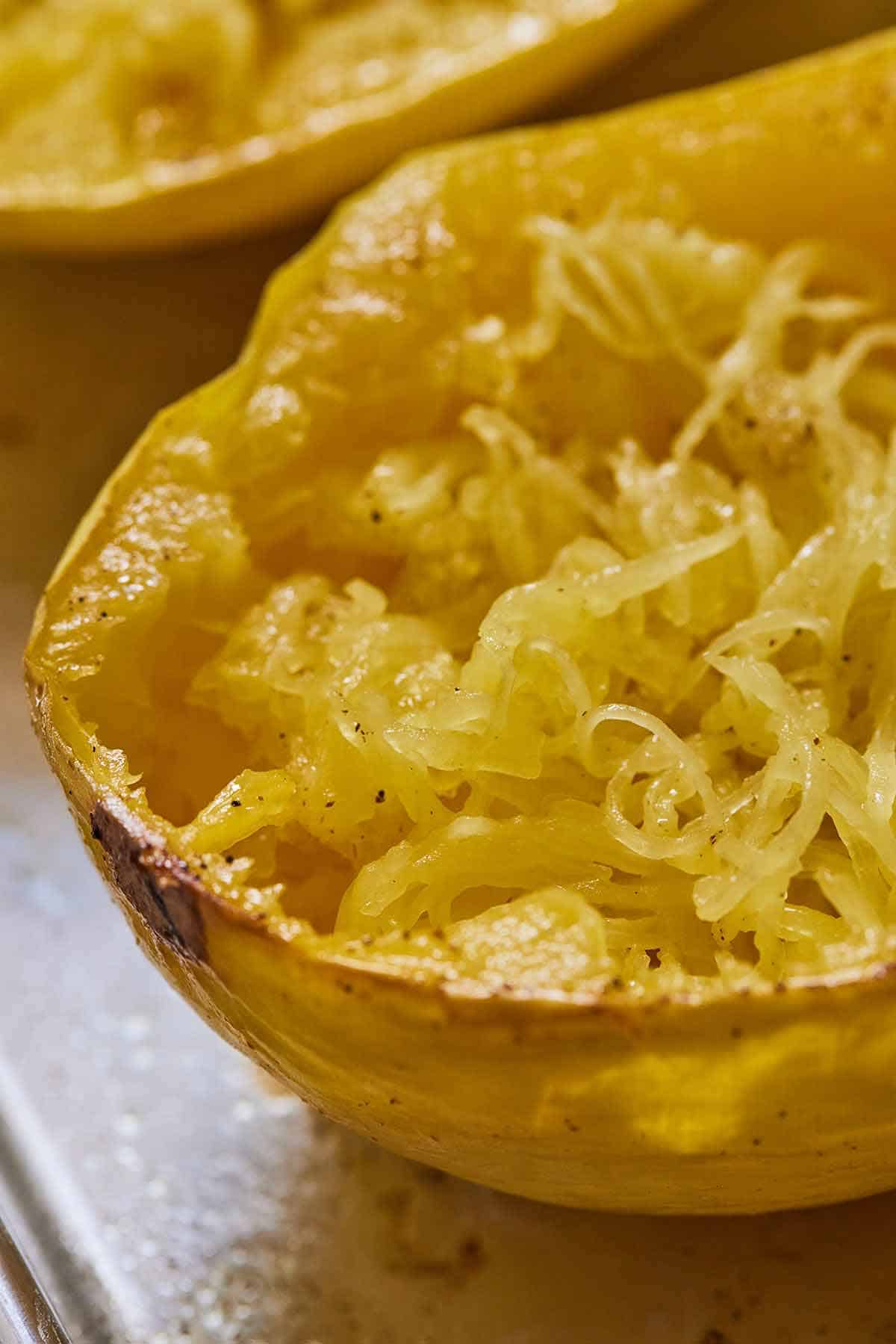 Close up of a spaghetti squash with the strands teased out.