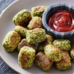 Pinterest graphic of a plate of broccoli tater tots with ketchup beside it.