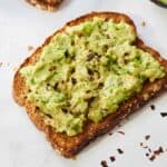 Avocado toast with red pepper flakes on top.