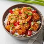 Bowl of sweet and sour shrimp over top rice.