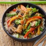 Bowl of vegetable stir fry over rice.