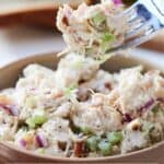 Pinterest graphic of a fork lifting up a bite of chicken salad from a bowl.