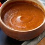 Pinterest graphic of a bowl of enchilada sauce.