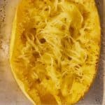 Pinterest graphic of the overhead view of half of a spaghetti squash on a sheet pan.
