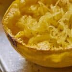 Pinterest graphic of spaghetti squash with the noodles scraped out.