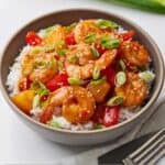Pinterest graphic of a bowl of sweet and sour shrimp over a bed of rice.