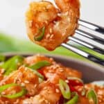 Pinterest graphic of a fork holding up a single sweet and sour shrimp.