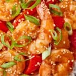 Pinterest graphic of multiple sweet and sour shrimp garnished with sesame and scalliions.