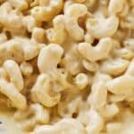 Pinterest graphic of macaroni coated in a vegan cashew cheese sauce.