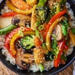 Pinterest graphic of a bowl of vegetable stir fry over a bed of rice.