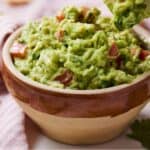 Pinterest image of a chip scooping out guacamole.