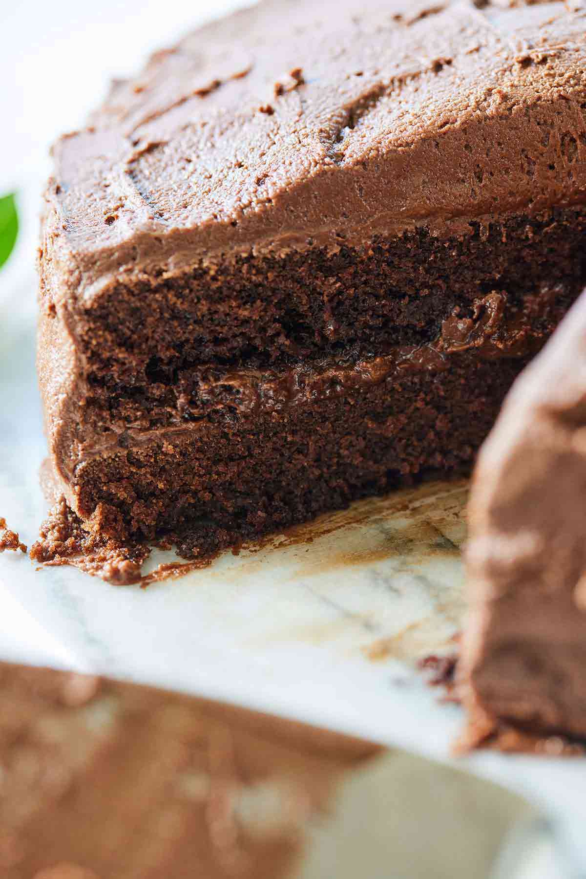 A cake with a slice taken out, focusing on the interior of the vegan chocolate cake.