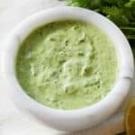 Overhead view of a bowl of green goddess dressing.