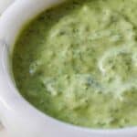 Pinterest graphic of a close up view of a small bowl of green goddess dressing.