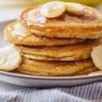 Pinterest graphic of a stack of paleo pancakes with sliced bananas.