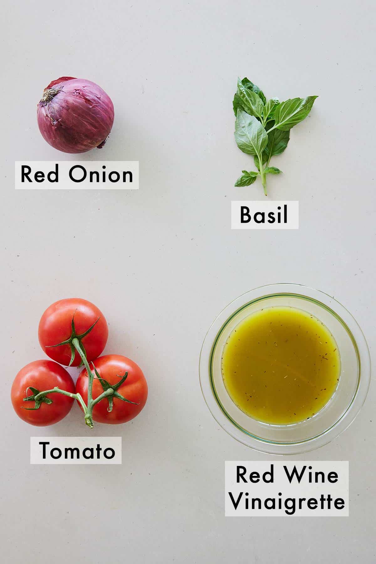 Ingredients needed to make a tomato salad.