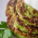 Pinterest graphic of the close up view of a stack of zucchini fritters.