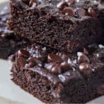 Pinterest graphic of two avocado brownies stacked on a plate.