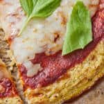 Pinterest graphic of a close up image of a slice of pizza made with cauliflower crust.