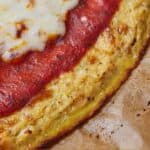 Pinterest graphic of a close up view of a cauliflower pizza crust.