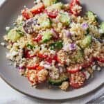 Pinterest graphic of a plate of Greek quinoa salad.