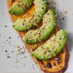 Pinterest graphic of sliced avocados over a sweet potato toast.