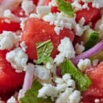Pinterest graphic of a close up view of a watermelon salad with fresh mint and feta.