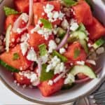 Pinterest graphic of an overhead view of a bowl of watermelon salad.