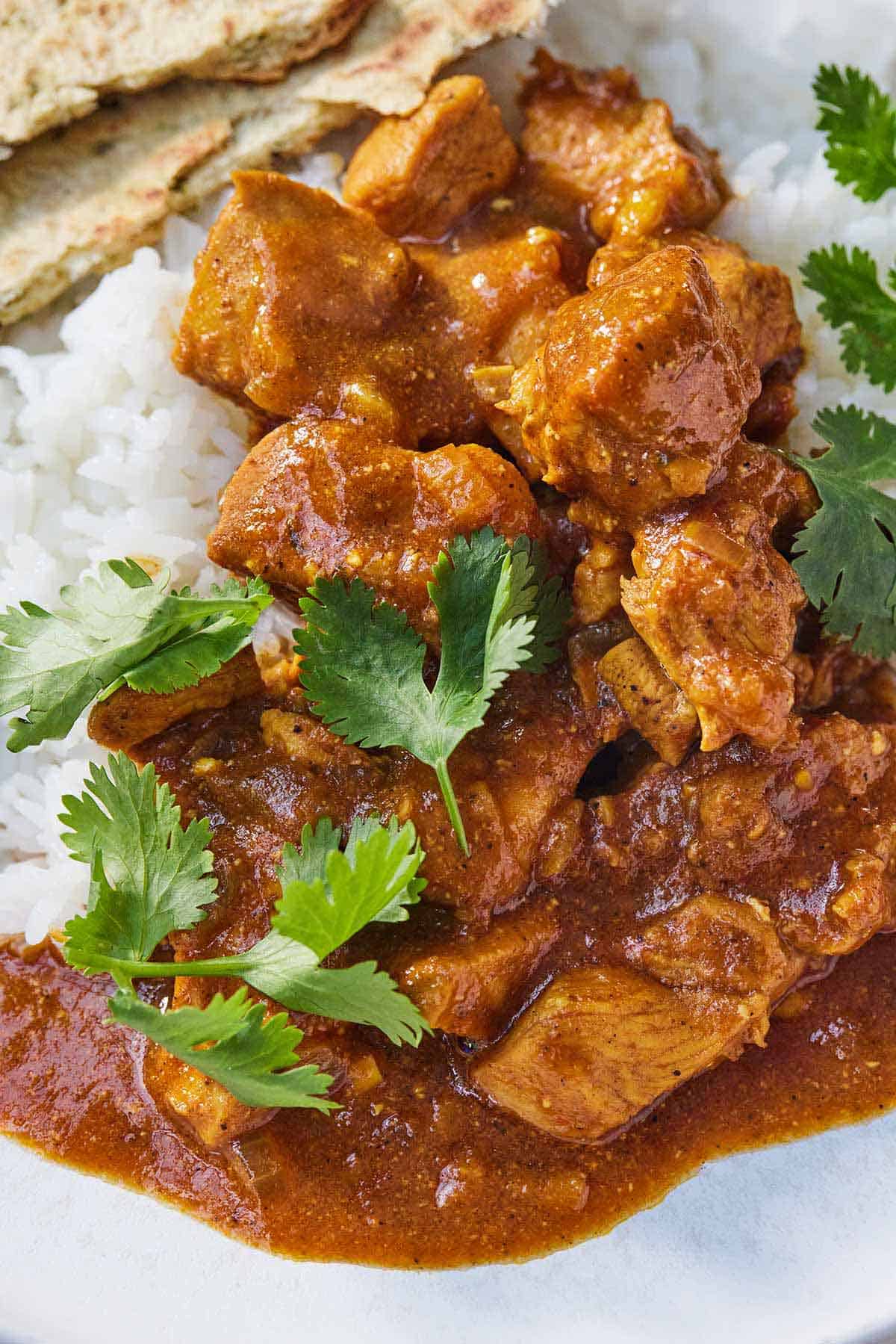 Instant Pot chicken tikka masala on a plate with cilantro on top.