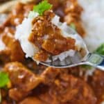 Pinterest graphic of a spoonful of Instant Pot chicken tikka masala with rice.