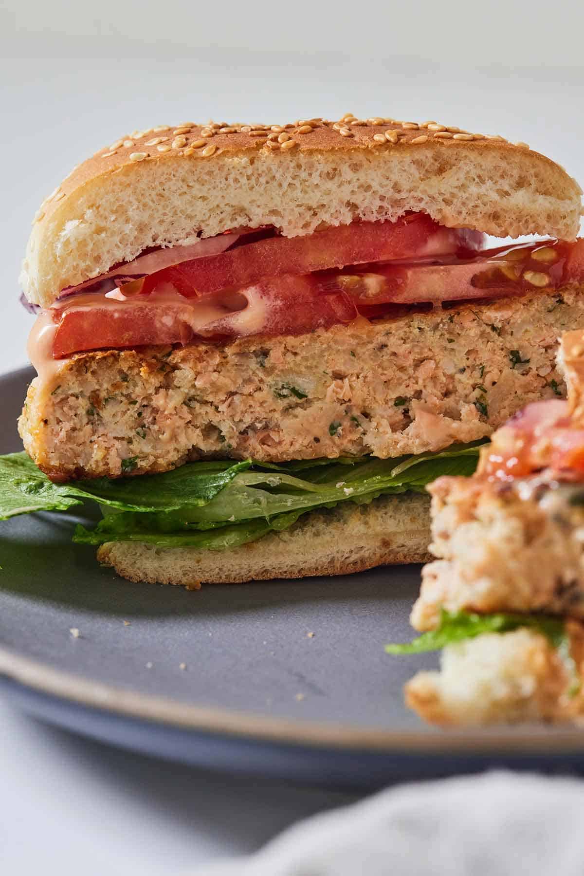 A salmon burgers, cut in half, showing the middle.