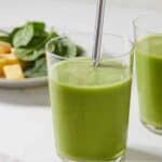 Pinterest graphic a green smoothie with a metal straw.