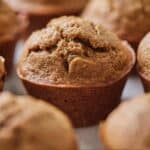 Pinterest graphic of healthy banana muffins with one in focus.