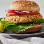 Pinterest graphic of a salmon burger on a plate.