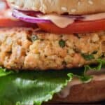Pinterest graphic of a close up view of a salmon burger.