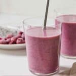 Pinterest graphic of a glass of dragon fruit smoothie in front of a second glass and some fruit.