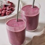 Pinterest graphic of an angled view of two glasses of dragon fruit smoothie with metal straws.