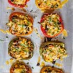Pinterest graphic of an overhead view of a sheet pan with vegetarian stuffed peppers.