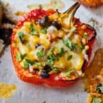 Pinterest graphic of a vegetarian stuffed pepper with cilantro sprinkled on top.