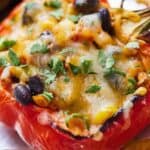 Pinterest graphic of a close up view of a vegetarian stuffed pepper with cilantro on top.