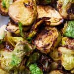 Pinterest graphic of a close up view of air fryer Brussels sprouts.