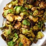 Pinterest graphic of a platter of air fryer Brussels sprouts.
